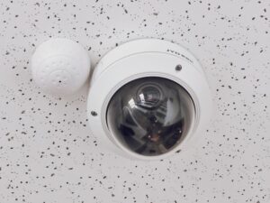 A round white CCTV camera, ideal for ensuring comprehensive coverage of commercial properties.