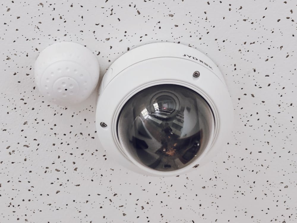 A round white CCTV camera, ideal for ensuring comprehensive coverage of commercial properties.