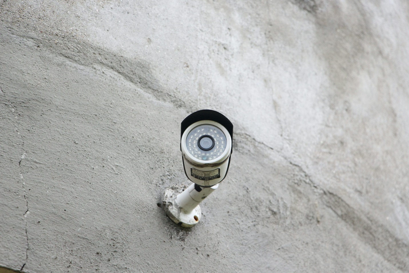 A camera on white wall as part of a home security camera installation