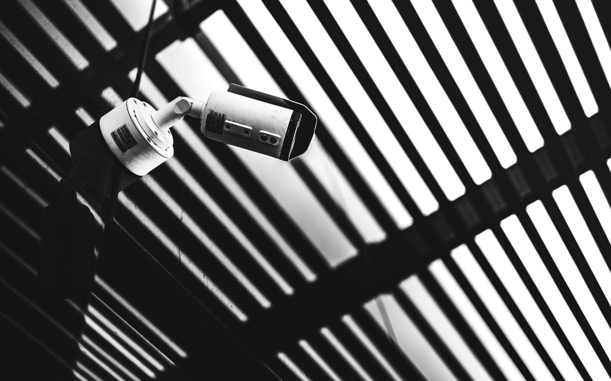 A close-up shot of a CCTV camera from below