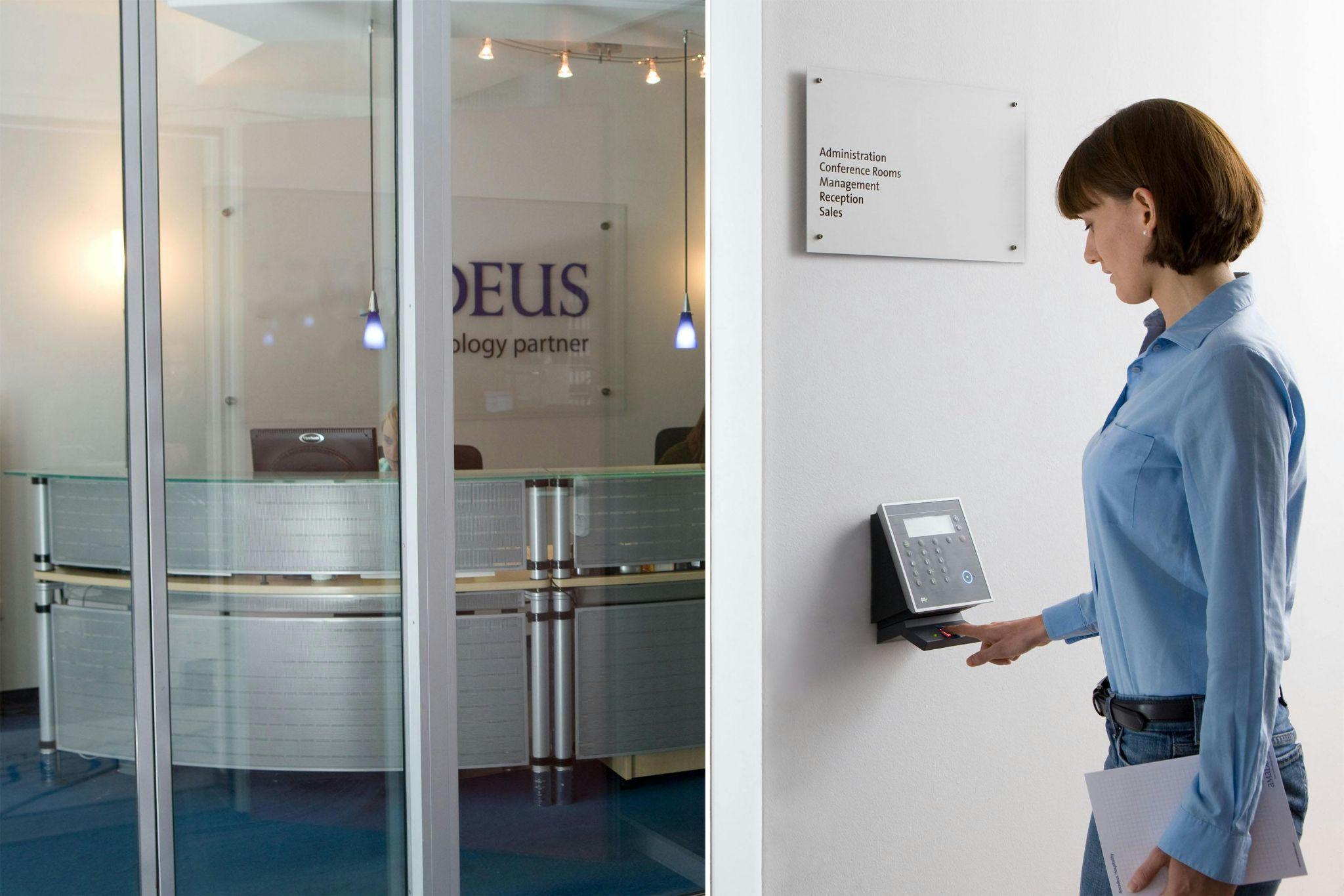 A person using a fingerprint biometric access control system in an office.