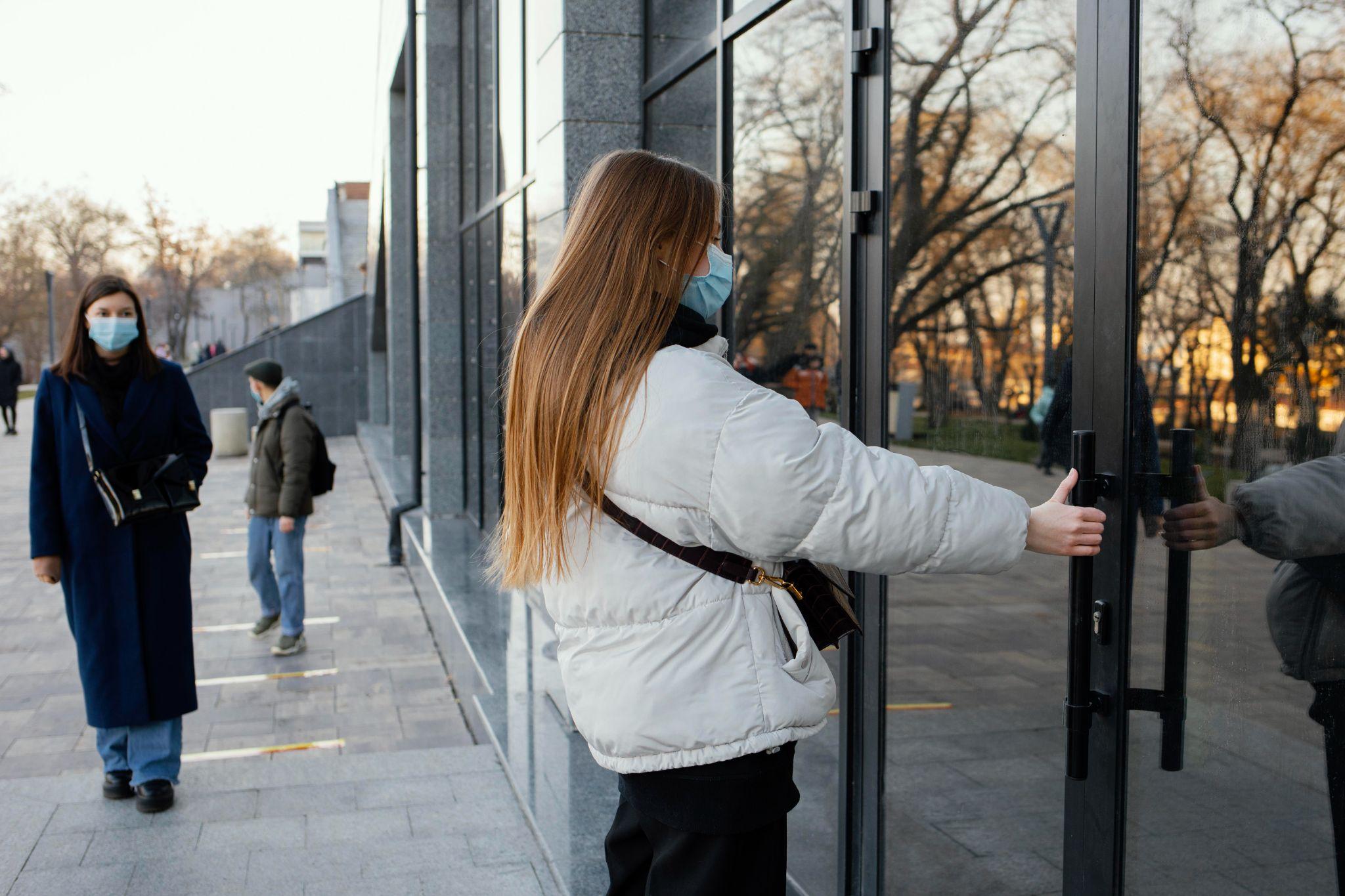 A person entering a building without using an access control system.