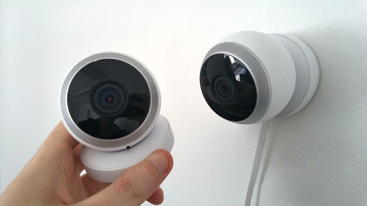 A person holding a CCTV camera in their hand