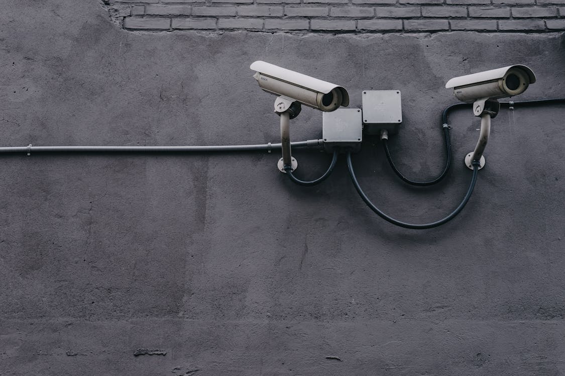 Two gray bullet security cameras, symbolizing the effectiveness of modern security technology in protecting homes through smart systems.