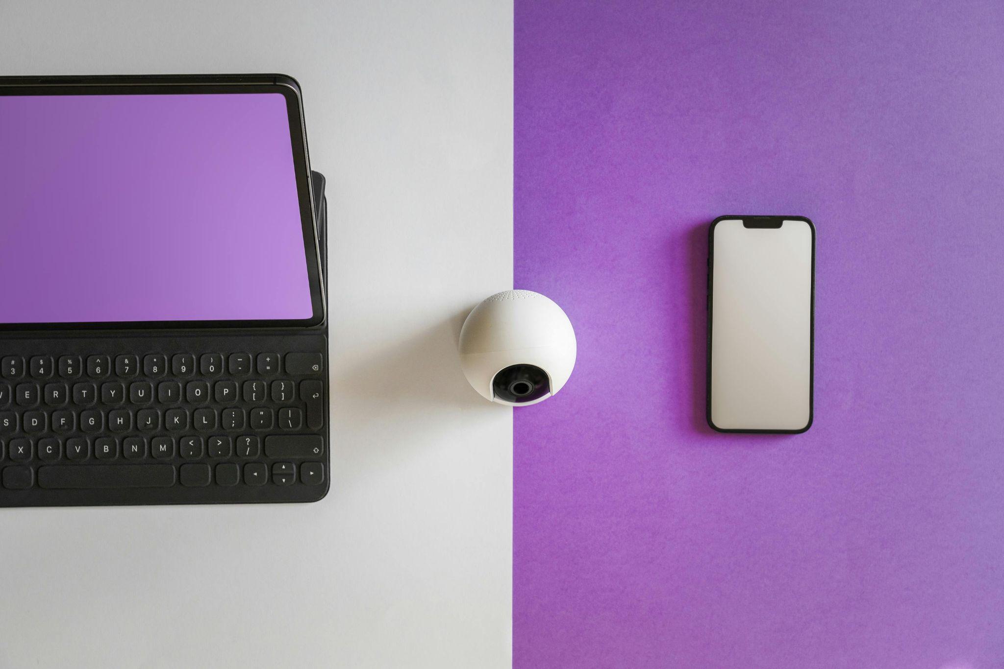  A phone, laptop, and CCTV camera arranged together