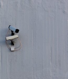 A security camera mounted on a wall, representing the importance of selecting the right security provider for protection.