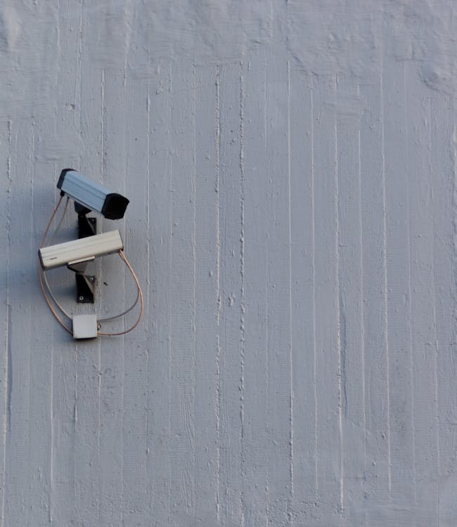 A security camera mounted on a wall, representing the importance of selecting the right security provider for protection.